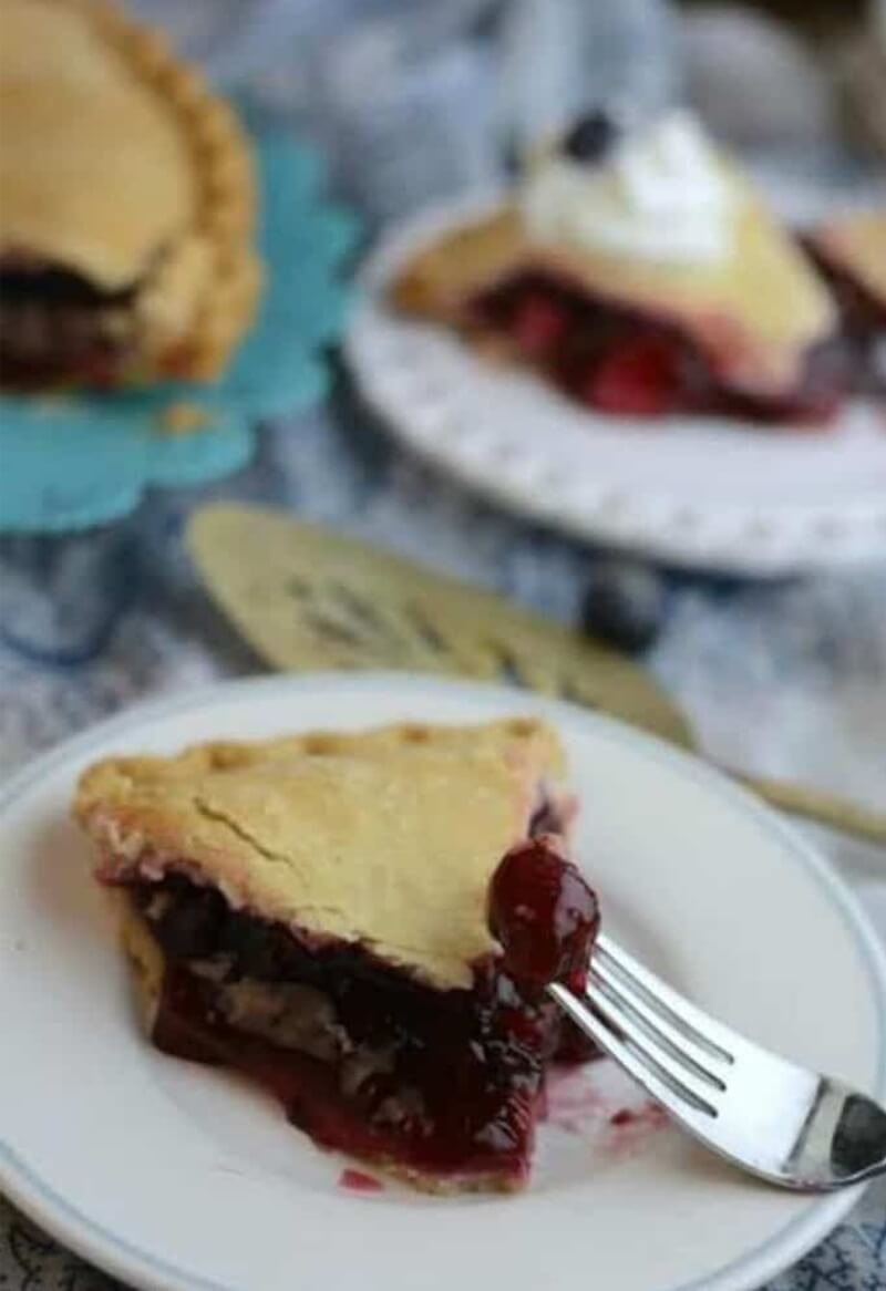 Berry Delicious Triple Berry Pie Recipe 11 Slice of Berry Delicious Triple Berry Pie with cherry on a fork
