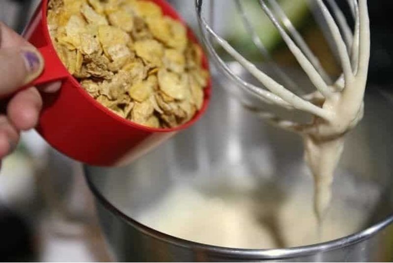 pouring cereal into cake batter