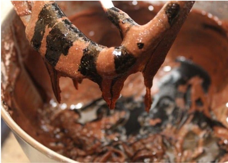 adding black food coloring to brownie batter