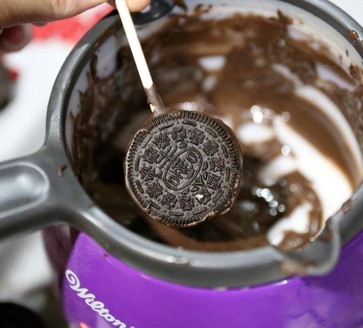 How to Make Reindeer Christmas Cookie Pops 14 dipping oreo cookie in chocolate