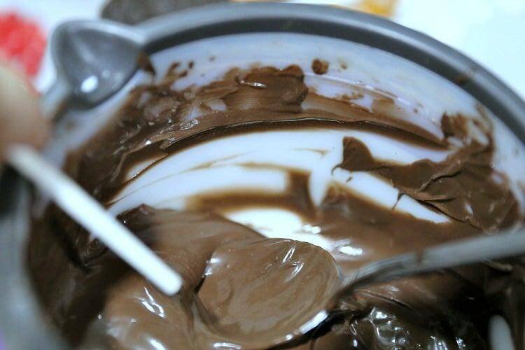 How to Make Reindeer Christmas Cookie Pops 12 dipping lolly pop stick in chocolate