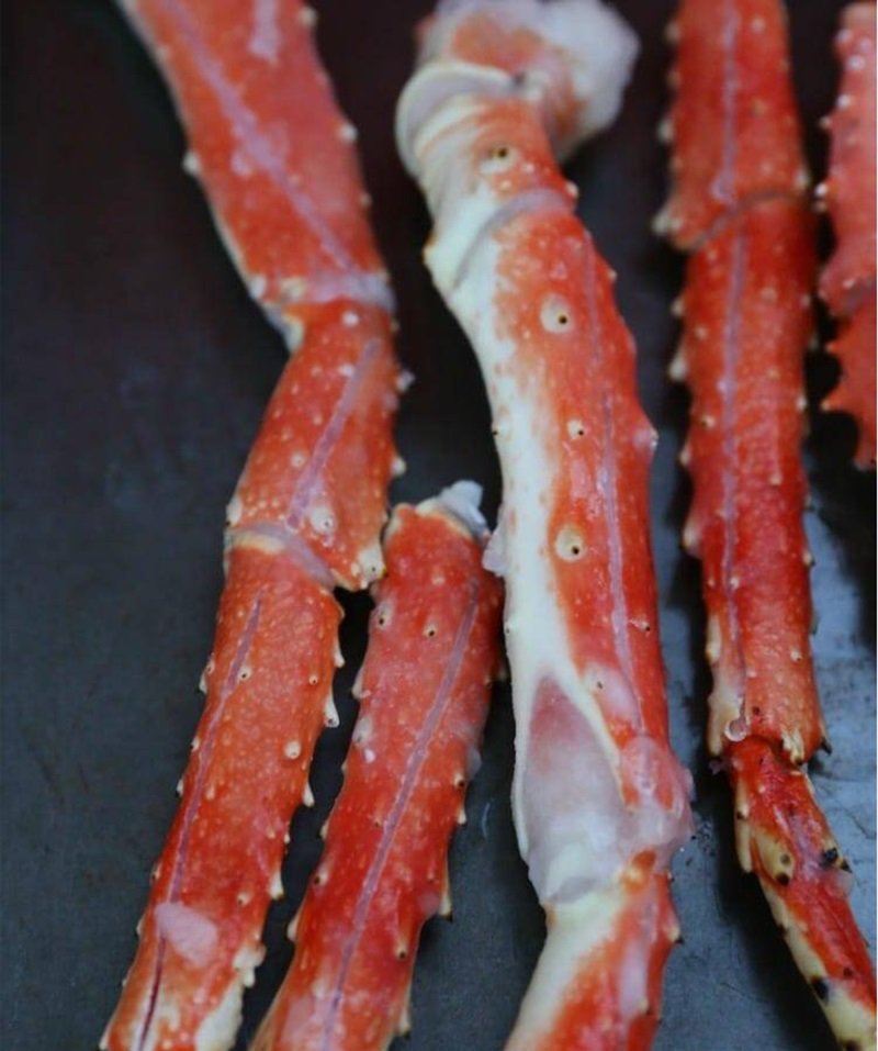 crab legs on baking sheet