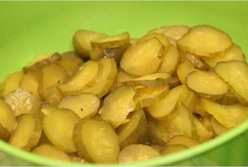 How To Make Tasty Fried Pickles 12 sliced pickles in a bowl