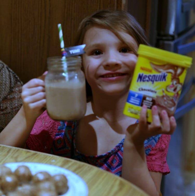 No-Bake Chocolate Peanut Butter Breakfast Balls 14 Jennifer brockman's daughter holding chocolate milk