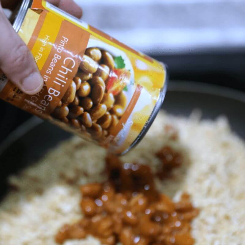 Easy Green Chili Chicken Taco Braid 14 adding chili beans to shredded chicken