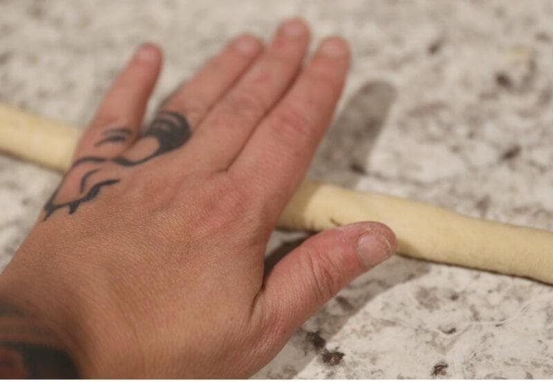 Delicious Homemade Soft Pretzels Stuffed with Brie Cheese 11 folding out dough for homemade soft pretzels