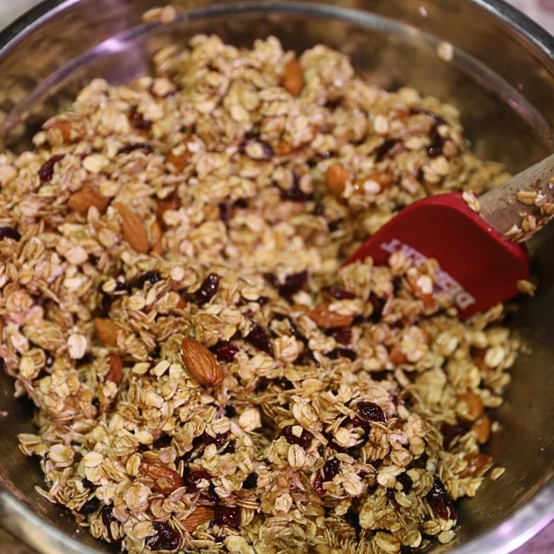 How To Make Homemade Granola 13 mixing granola in large bowl