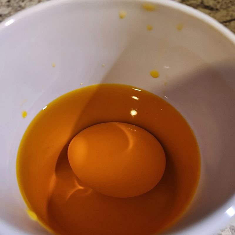 How To Color Easter Eggs With Food Coloring 11 Egg sitting in food coloring