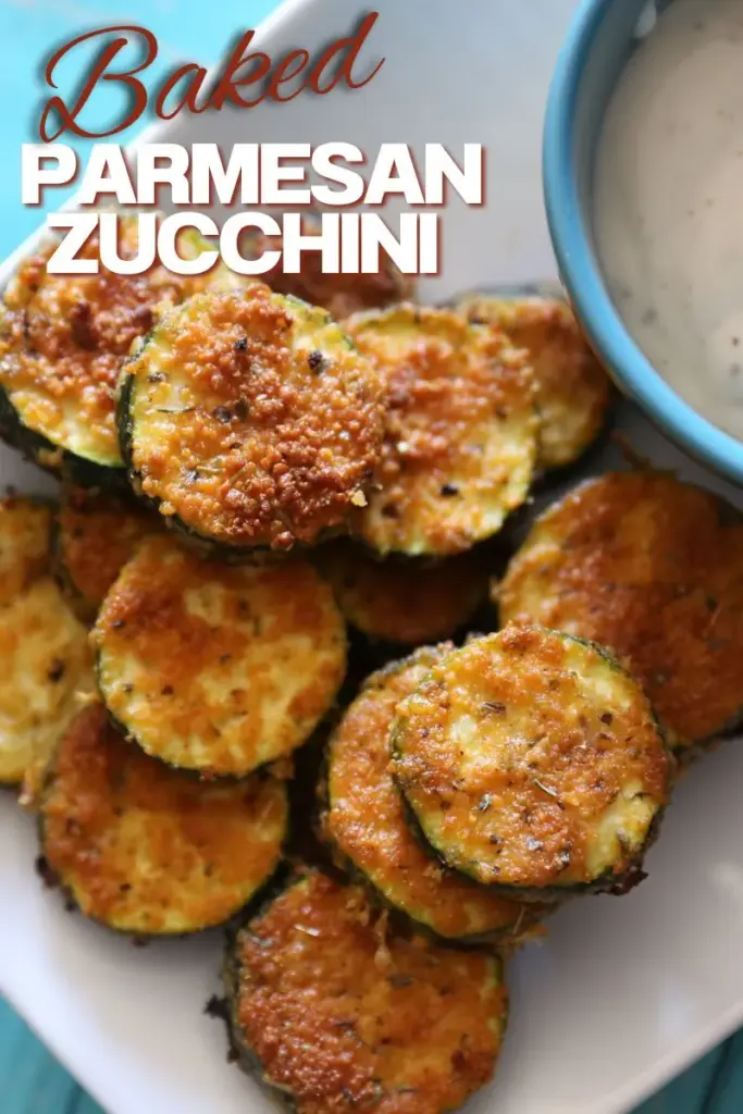 Easy Baked Parmesan Zucchini on white plate with ranch in a blue bowl on the side.