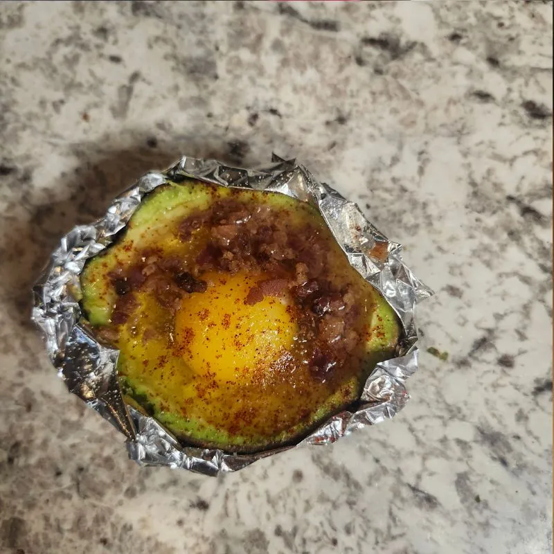 Loaded Southwest Baked Avocado Egg Boats with foil preparing to go into the oven.