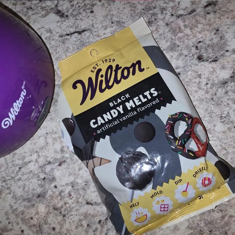 Easy No Bake Halloween Ghost Oreo Balls 14 Wilton black candy melts on counter next to wilton melting pot